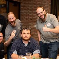 seven people celebrating at luncheon table